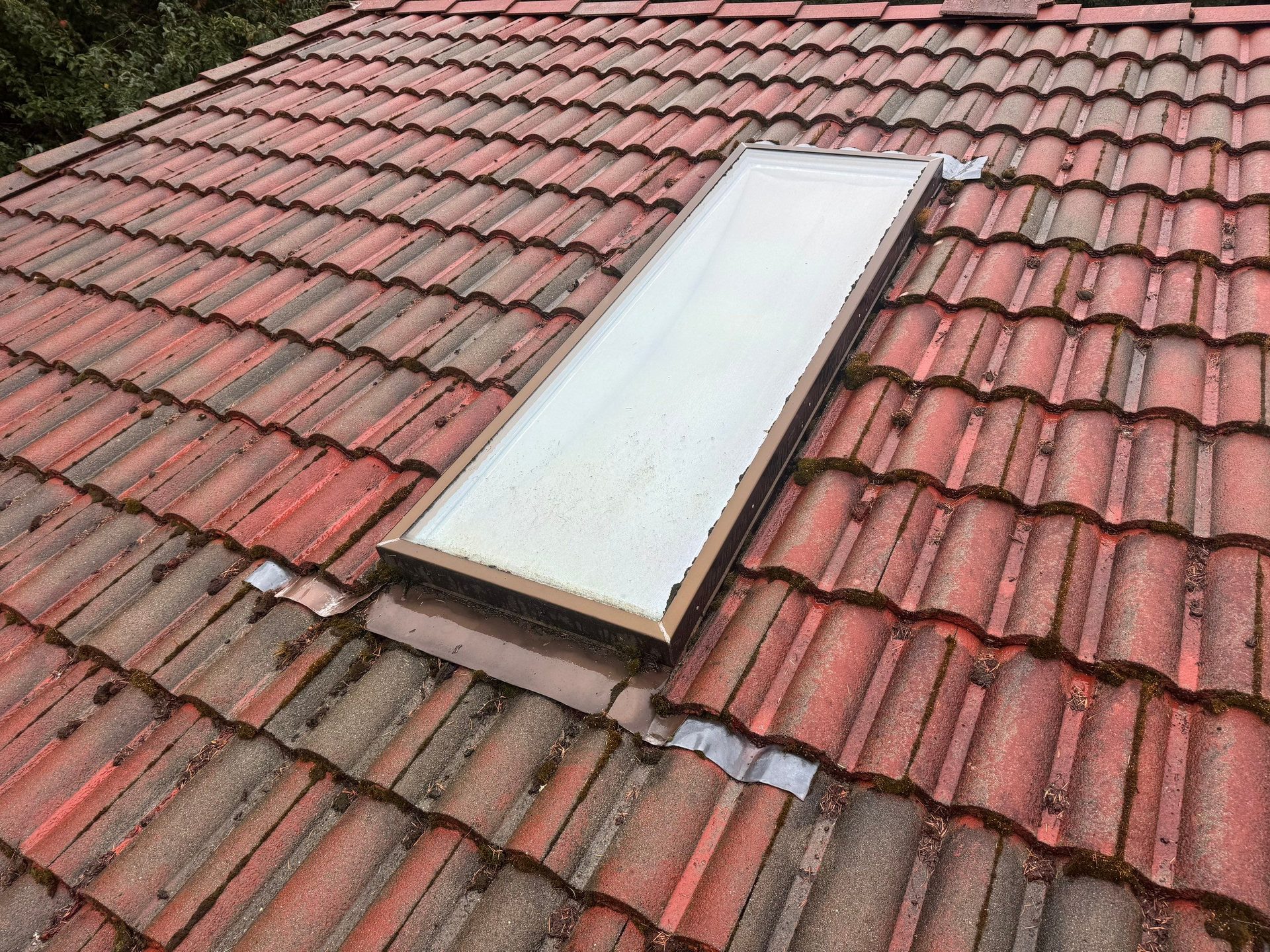 Pre-existing roof damage documented before Antique Clay Brava Spanish barrel tile replacement in Camano Island, WA